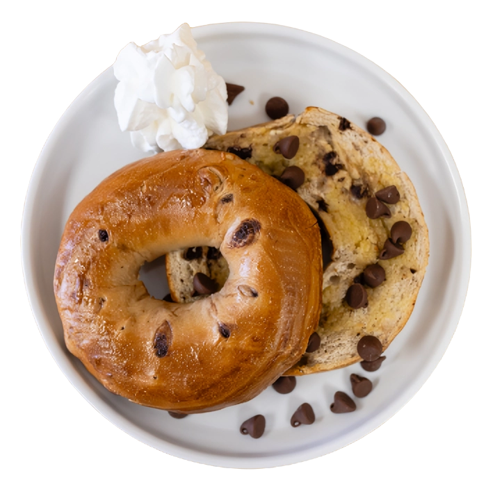 A plate of food with two donuts and chocolate chips.